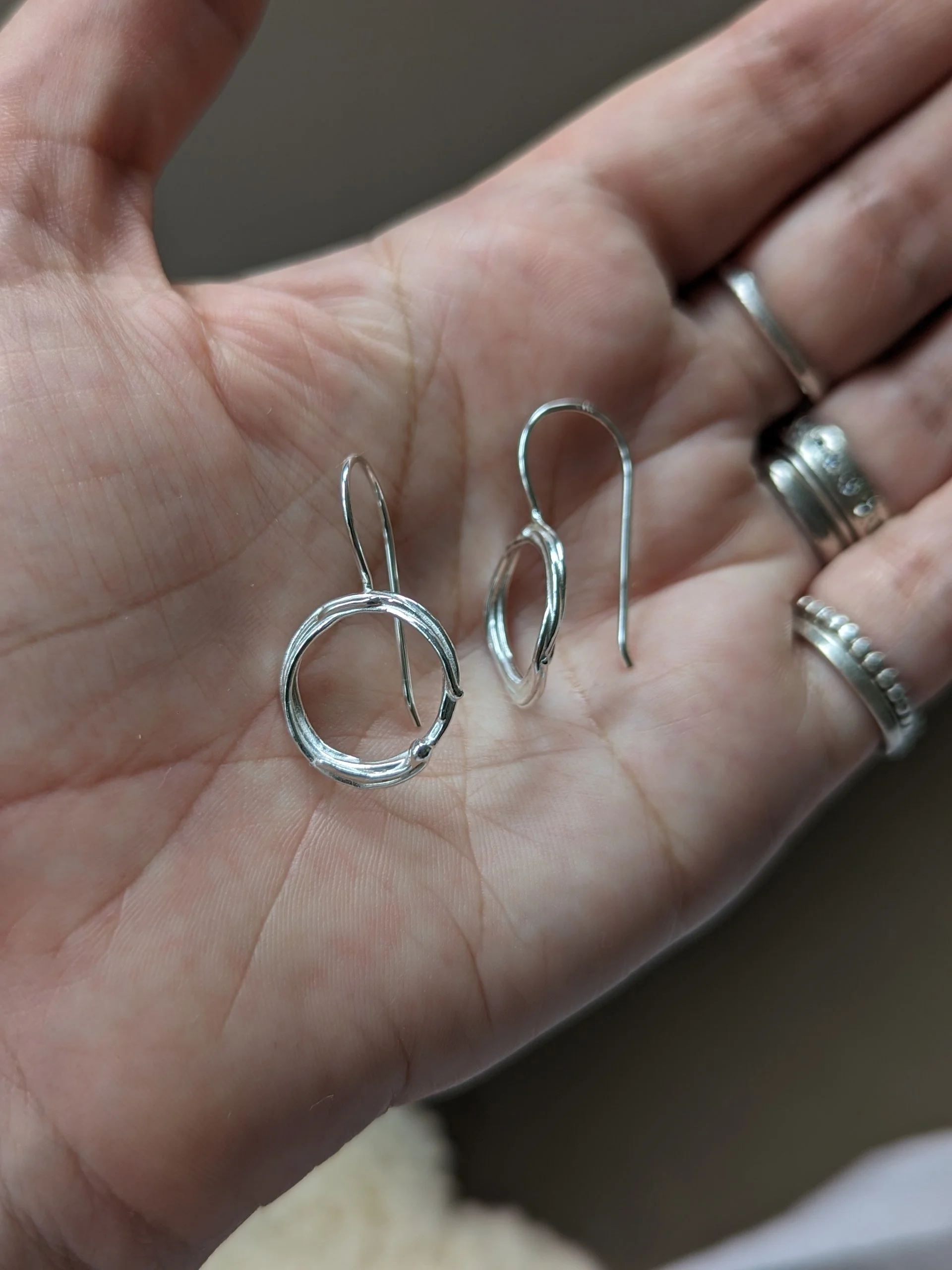 Large scribble drop earrings B on hand.jpg