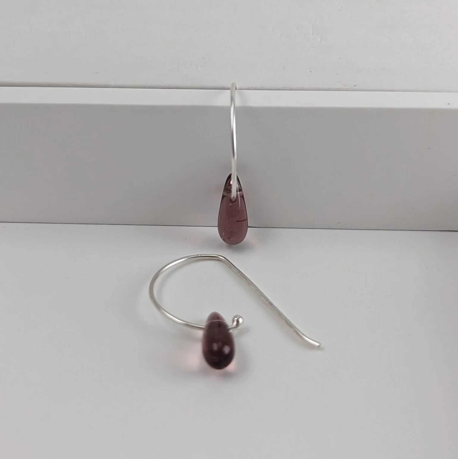 Amethyst coloured tiny glass teardrop earrings