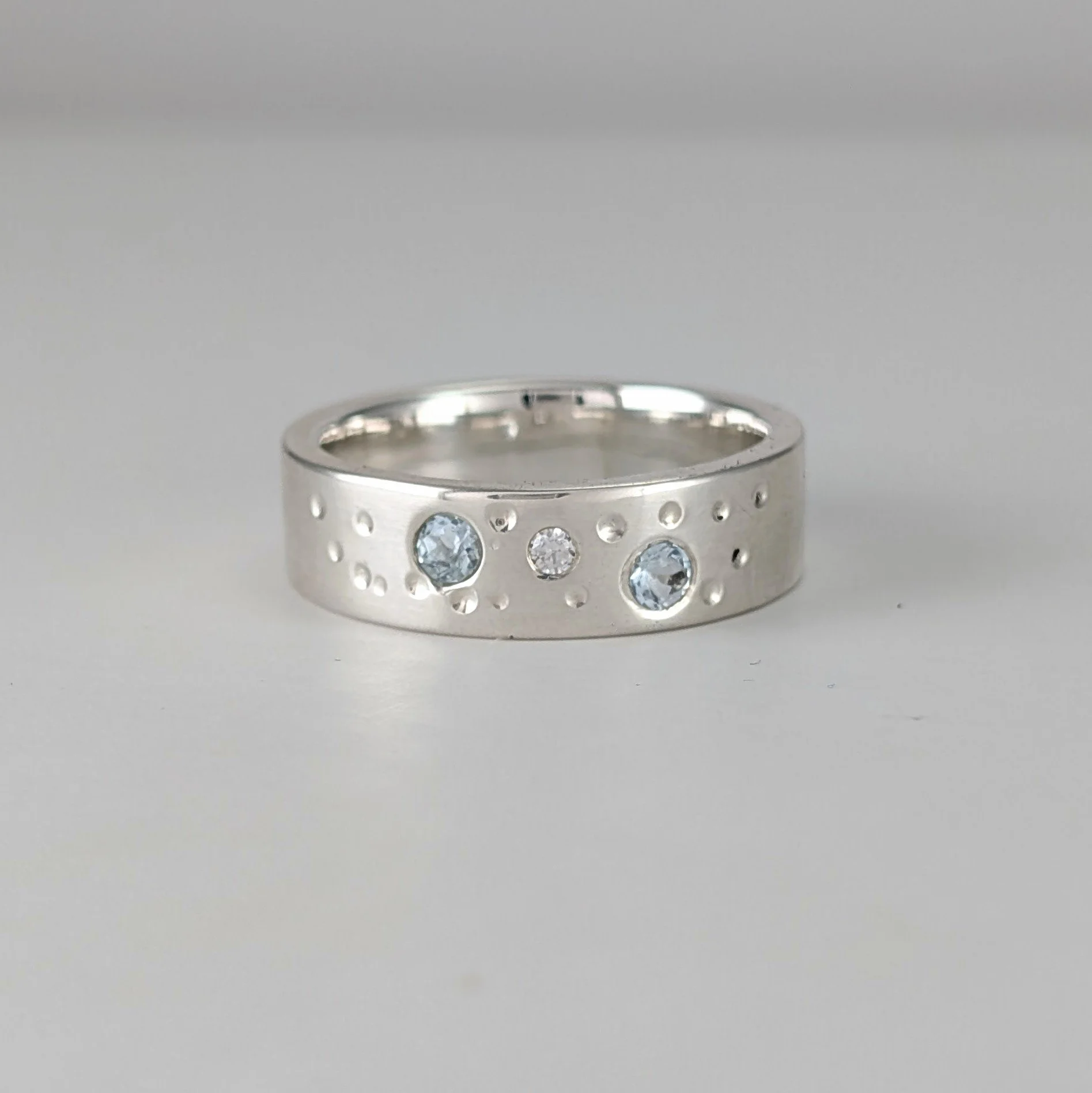 Thick ring band with blue topaz and cz