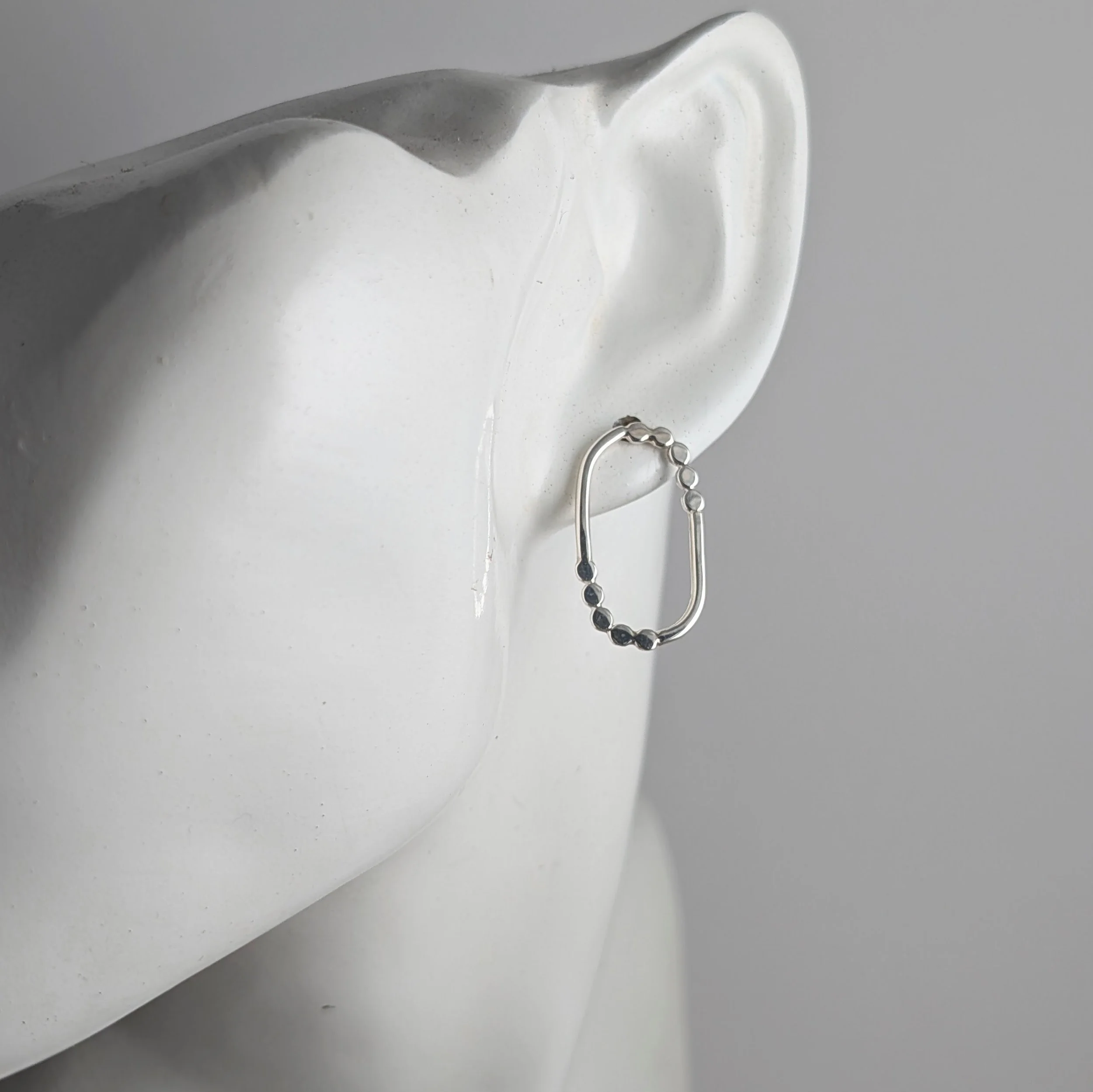 Oval-dotted-border-studs-on-ear.jpg