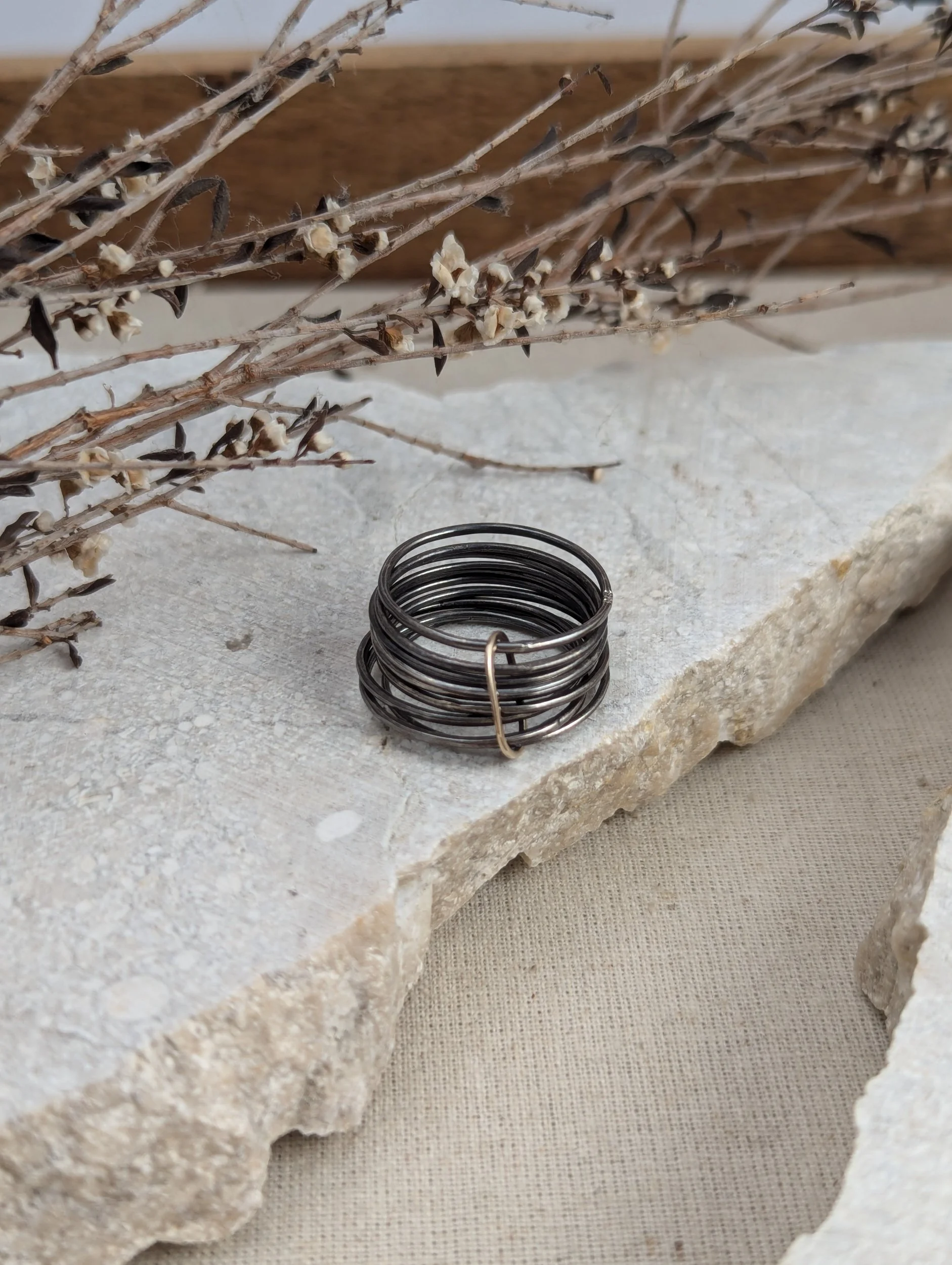 Oxidised silver rings with 9ct gold band wrap