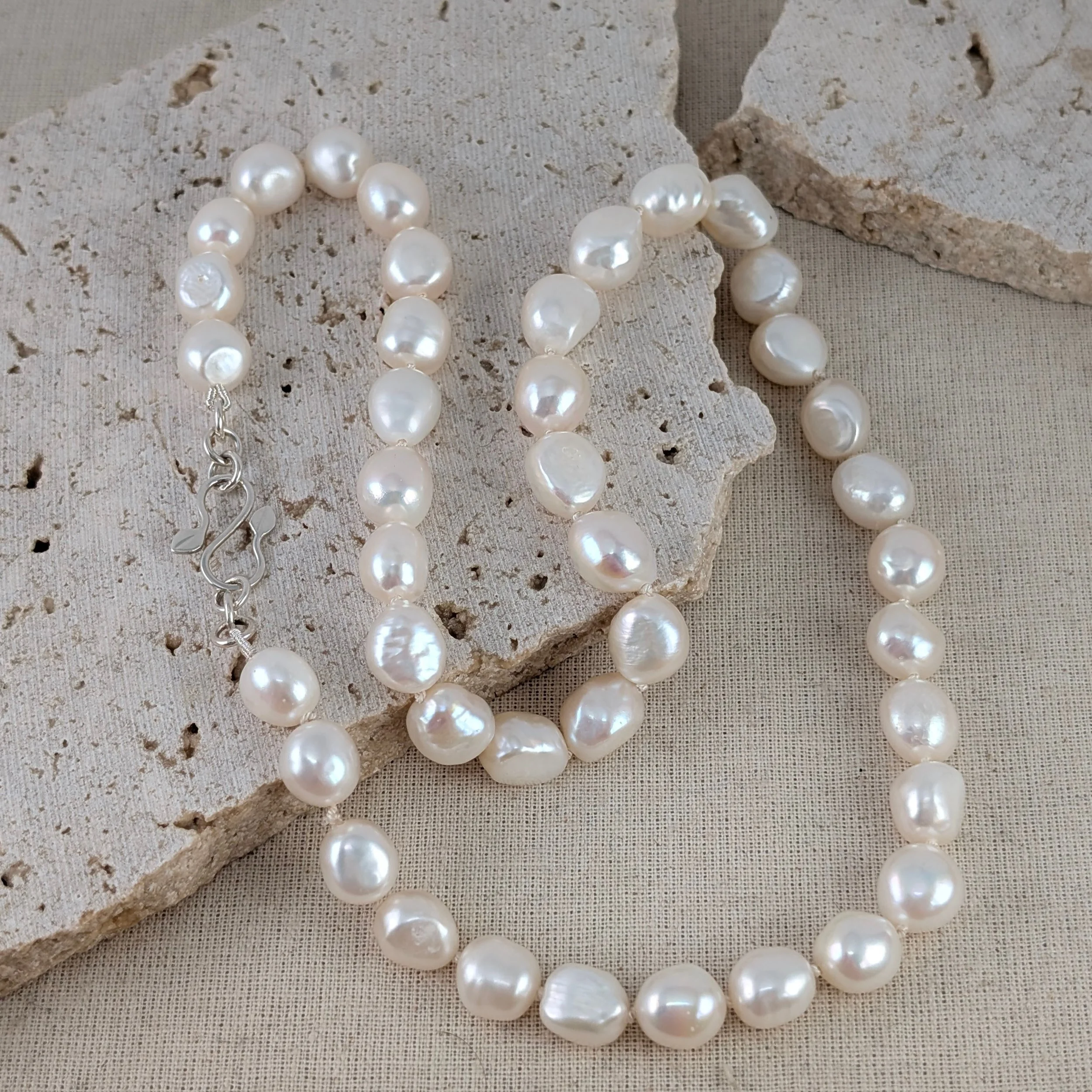 Knotted pearl necklace with leaf catch v1.jpg