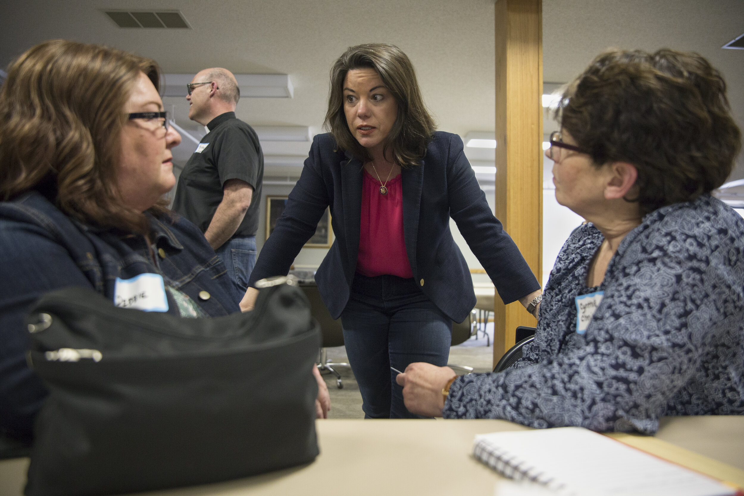  U.S. Congresswoman Angie Craig (center), representing the second district of Minnesota, speaks with Debbie Mills - Minnesota's Goodhue County Farmers Union President (left), and Cynthie Christensen - therapist and President of Houston County Farm Bu