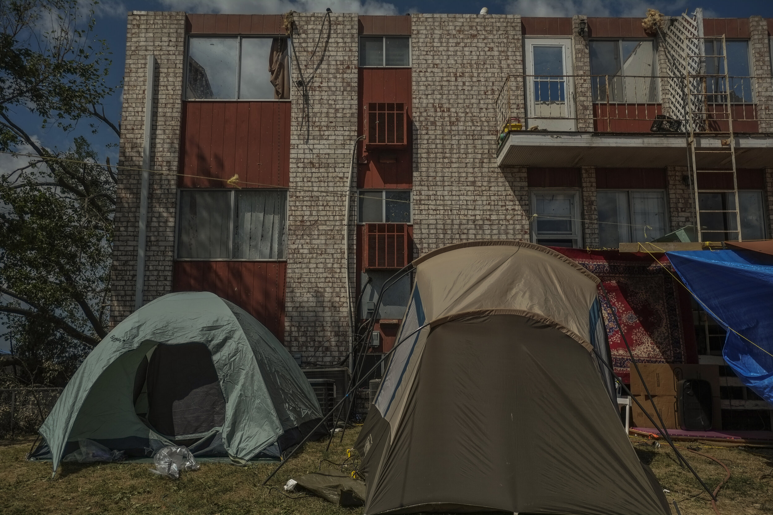  Tents serve as temporary housing for recently displaced families from Cedar Terrace apartments in southeast Cedar Rapids, Iowa on August 16th, 2020. With severe internal and external damage, this community became unlivable as housing infrastructure 