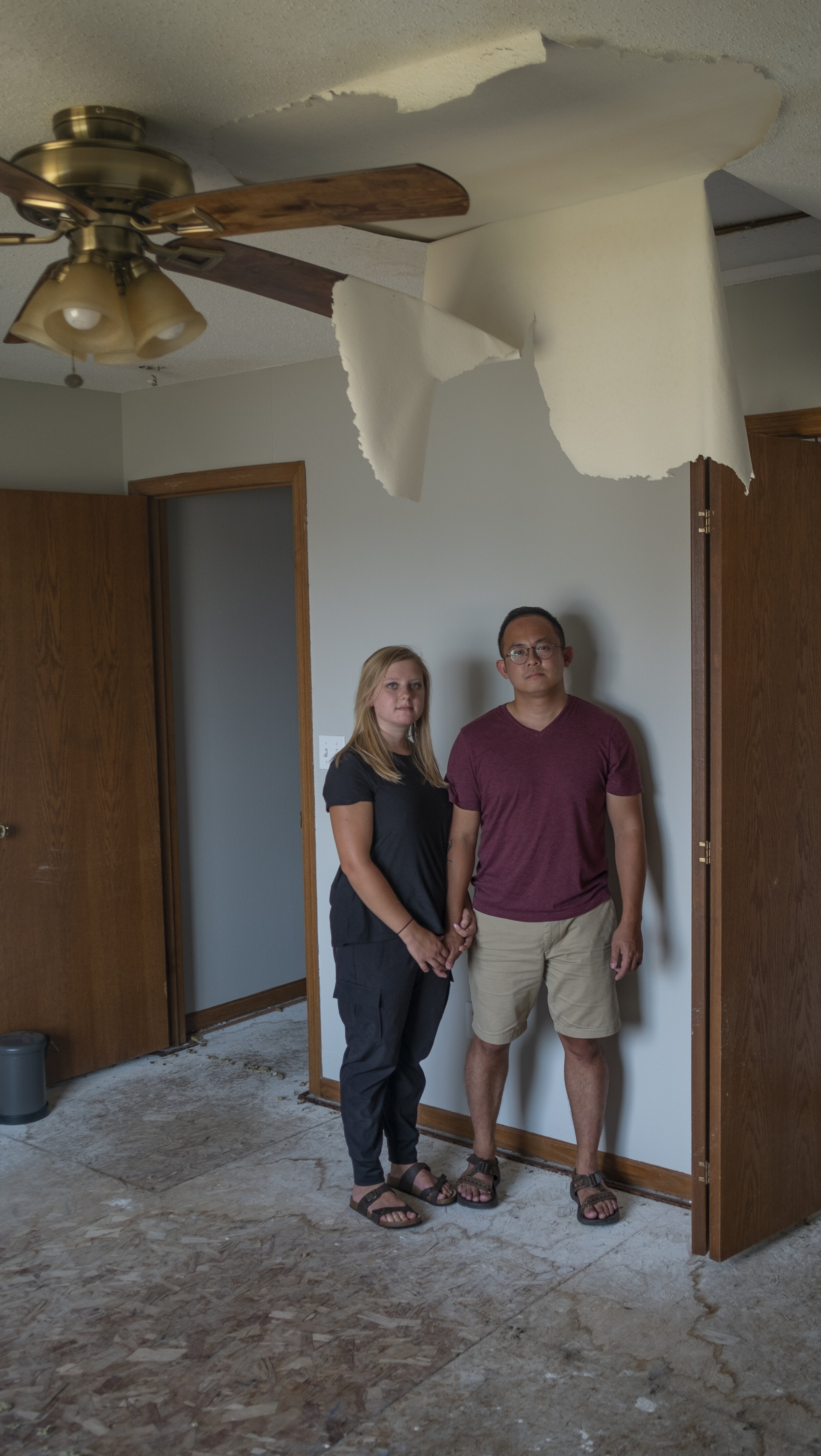  Jessie Lau (left) and Adam Lau stand in the bedroom of their apartment in Marion, Iowa on Friday, August 27th, 2020. After the Lau’s residence sustained major damage and was determined unfit to live in, they relocated and moved in with other family 