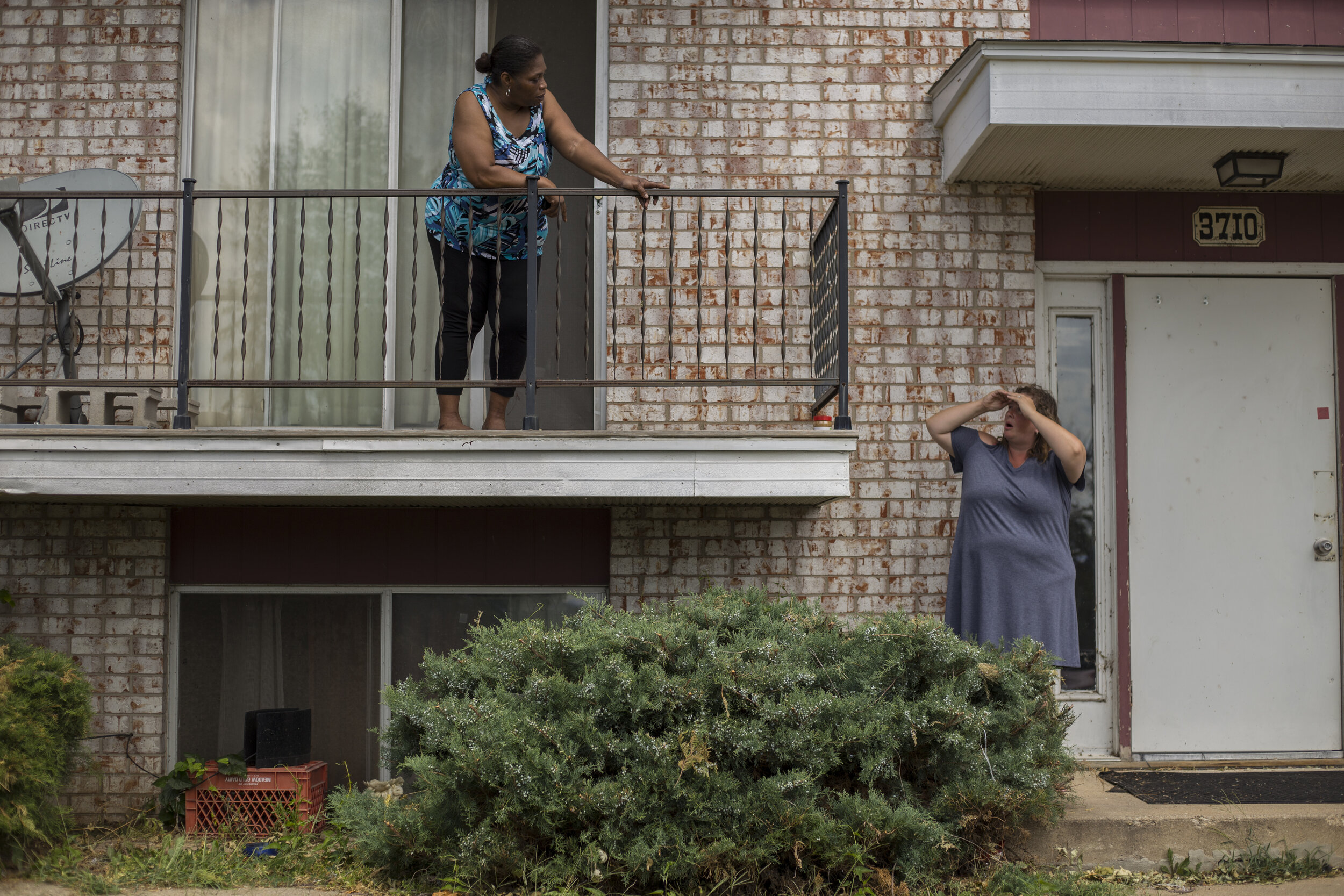  Neighbors Angela Marion (left), and Jennifer Boggs talk outside of their apartments on the southwest side of Cedar Rapids, Iowa on Sunday, August 16th, 2020. The Cedar Rapids power grid was shattered and nearly half a million Iowans were left withou