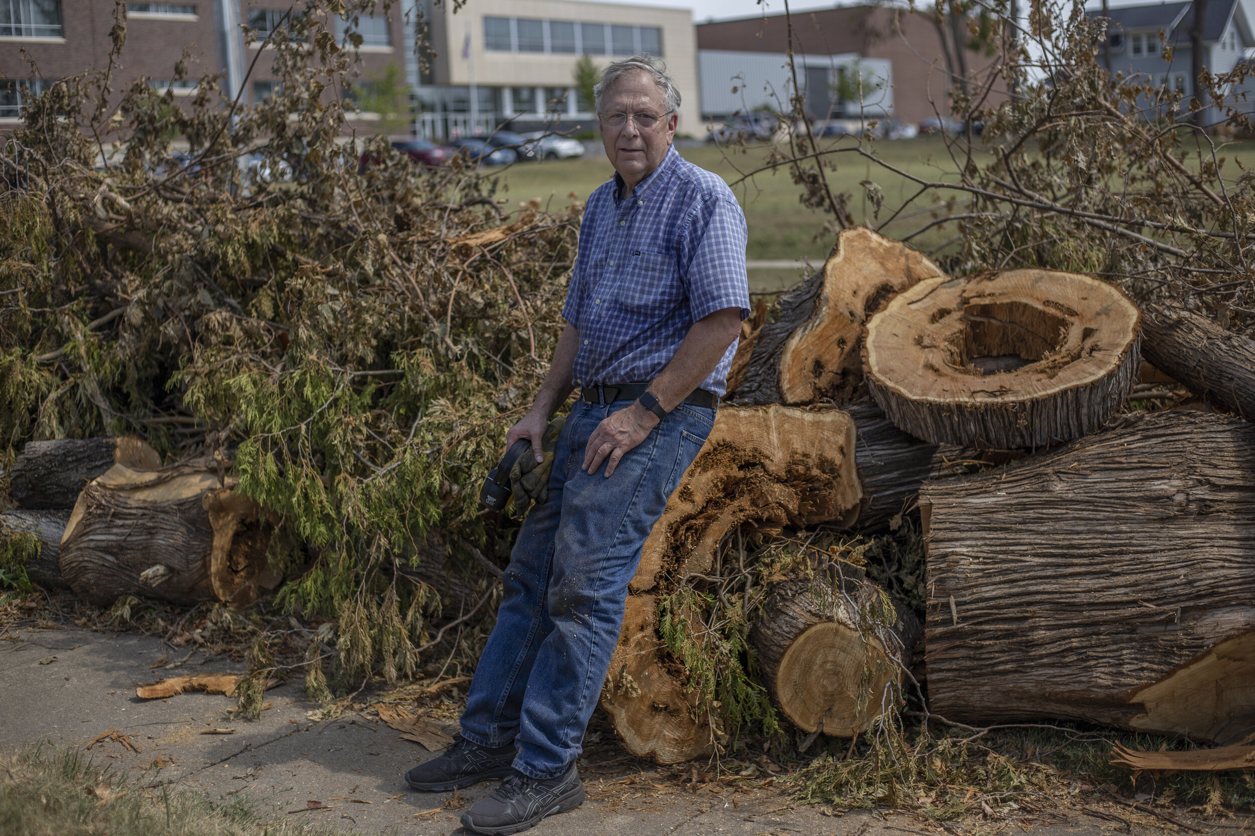  Ron Thatcher takes a break from yard work in front of his home on Saturday, August 28th, 2020 in Marion, Iowa. Thatcher, who has lived in Marion for 50 years, had to cut down multiple trees in his yard after they fell and caused structural damage to