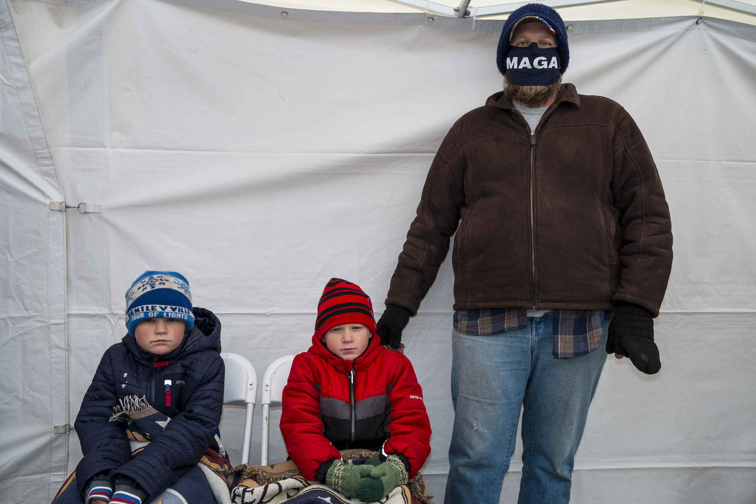  (From left) Charlie, Zacch, and Chris Reed wait in warming tents for Vice President Mike Pence to arrive at the Range Regional Airport on October 26, 2020 in Hibbing, Minnesota. (Photo by Brooklynn Kascel/Getty Images) 