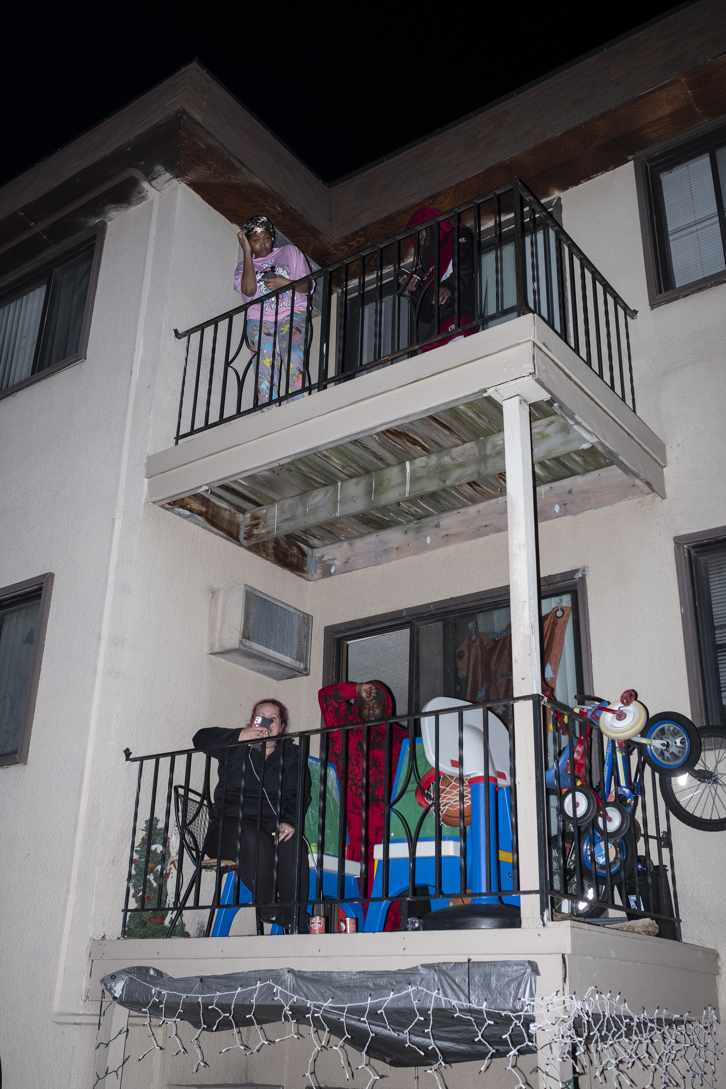  Residents of Brooklyn Center, Minnesota stand on their porches as members of local law enforcement clash with protesters outside of the Brooklyn Center Police Department on Sunday, April 12th. Demonstrators gathered in large numbers to hold this pol