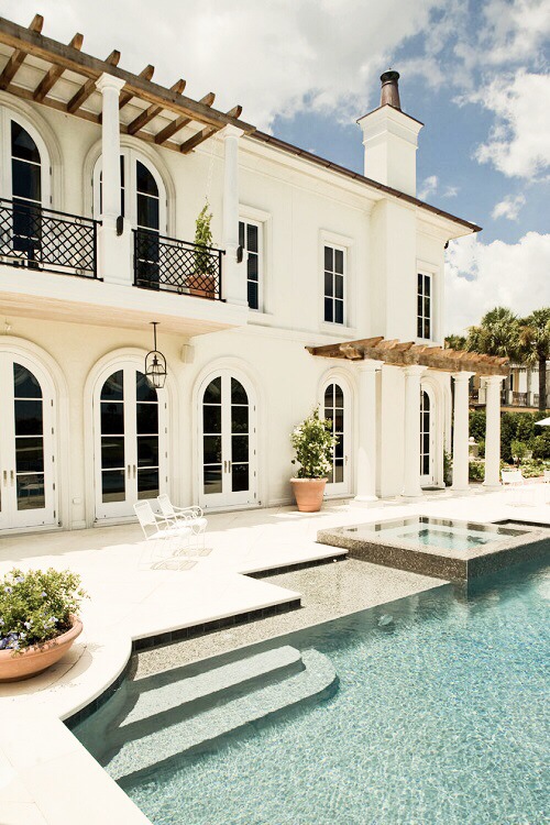The worn wood on the all white exterior of this dream home keeps it from feeling too stark. 