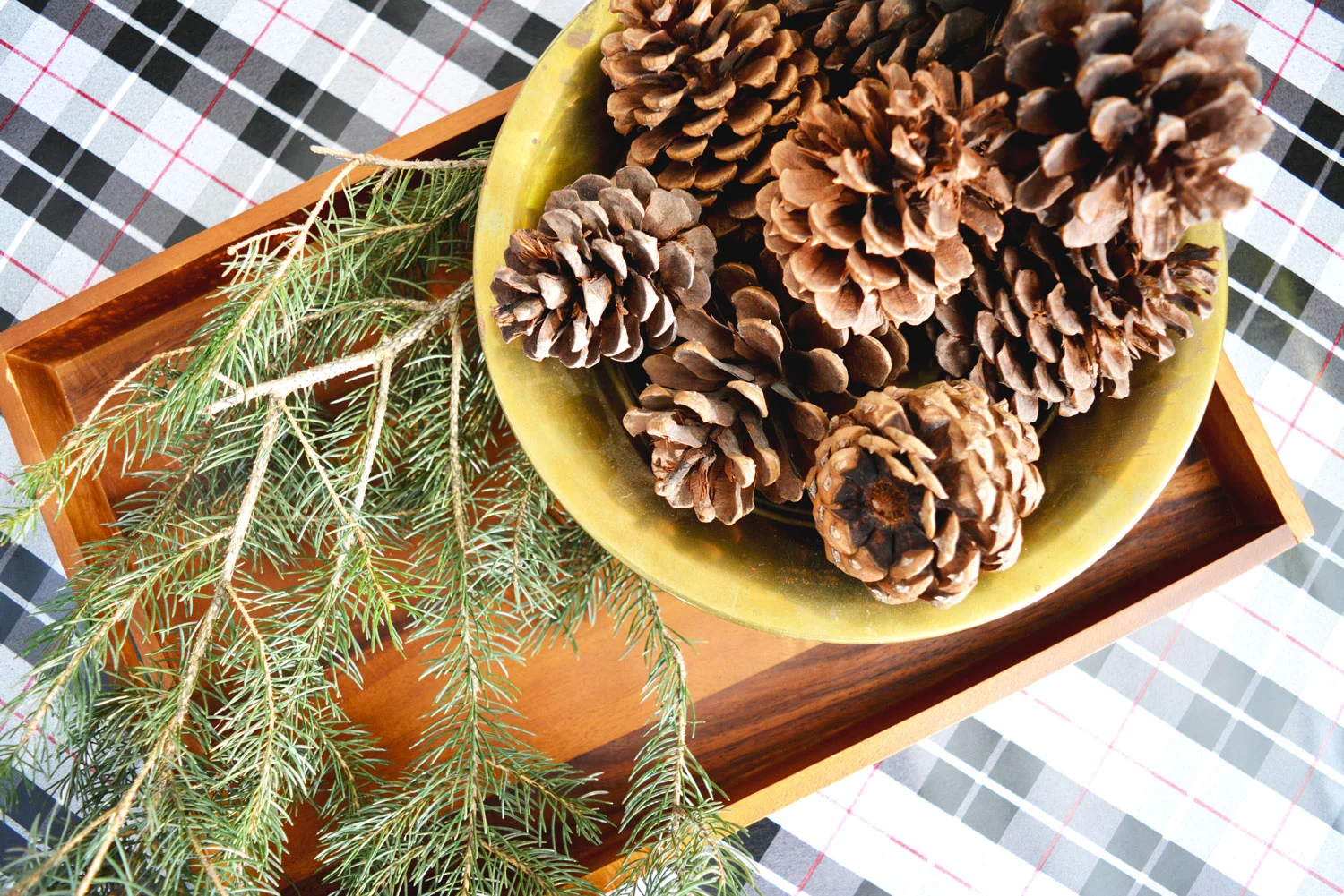 Add a sprig of fresh greenery to a simple wooden tray for some casual Christmas style.