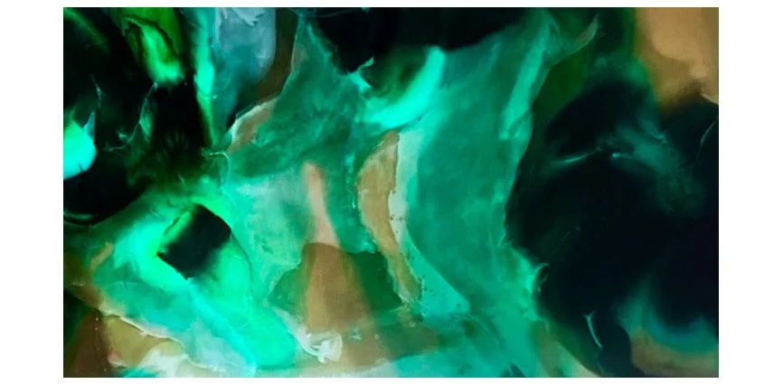Abstract image with swirling green and blue colors.