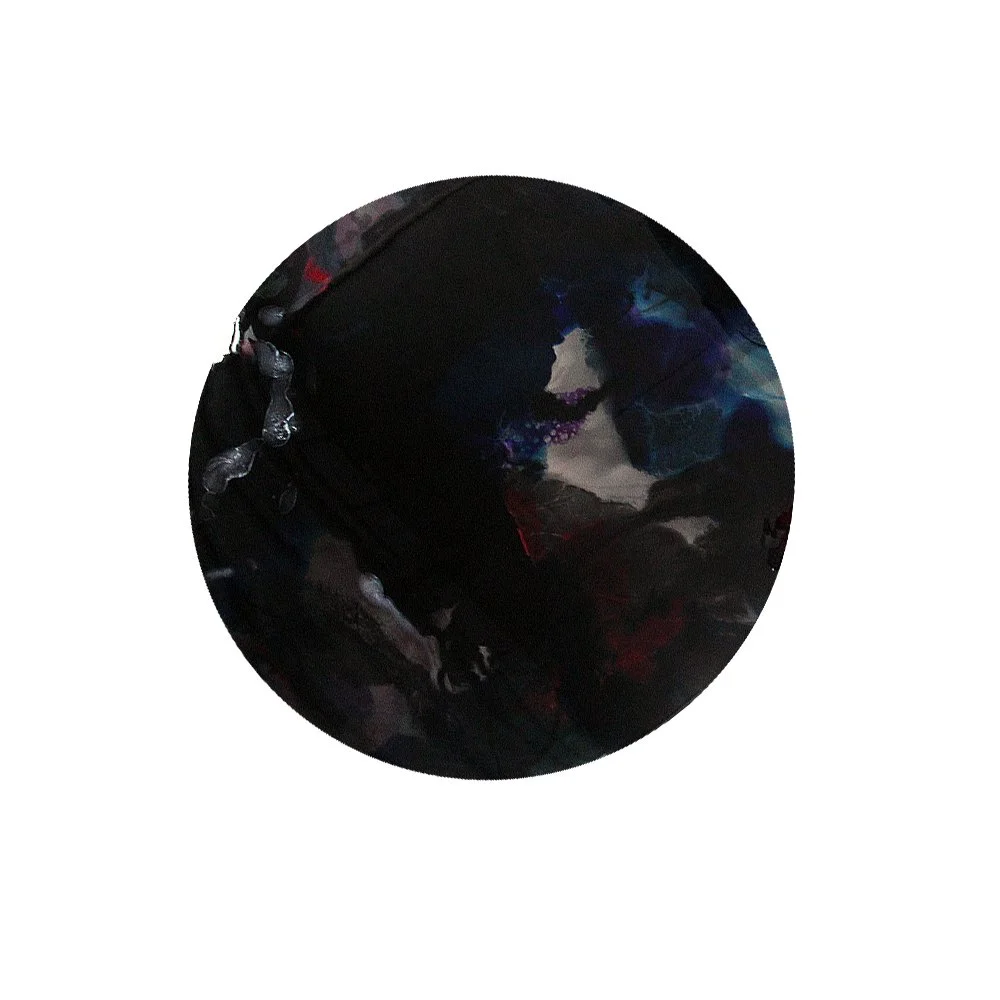 Close-up of a spherical object with a dark, abstract design and hints of blue, purple, and red, on a white background.