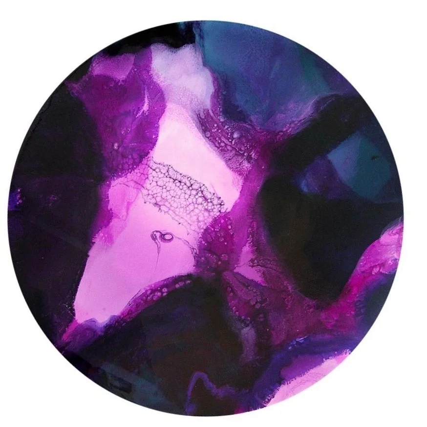 Abstract circular artwork with flowing shades of purple, pink, and dark blue, resembling fluid art or watercolor blending.