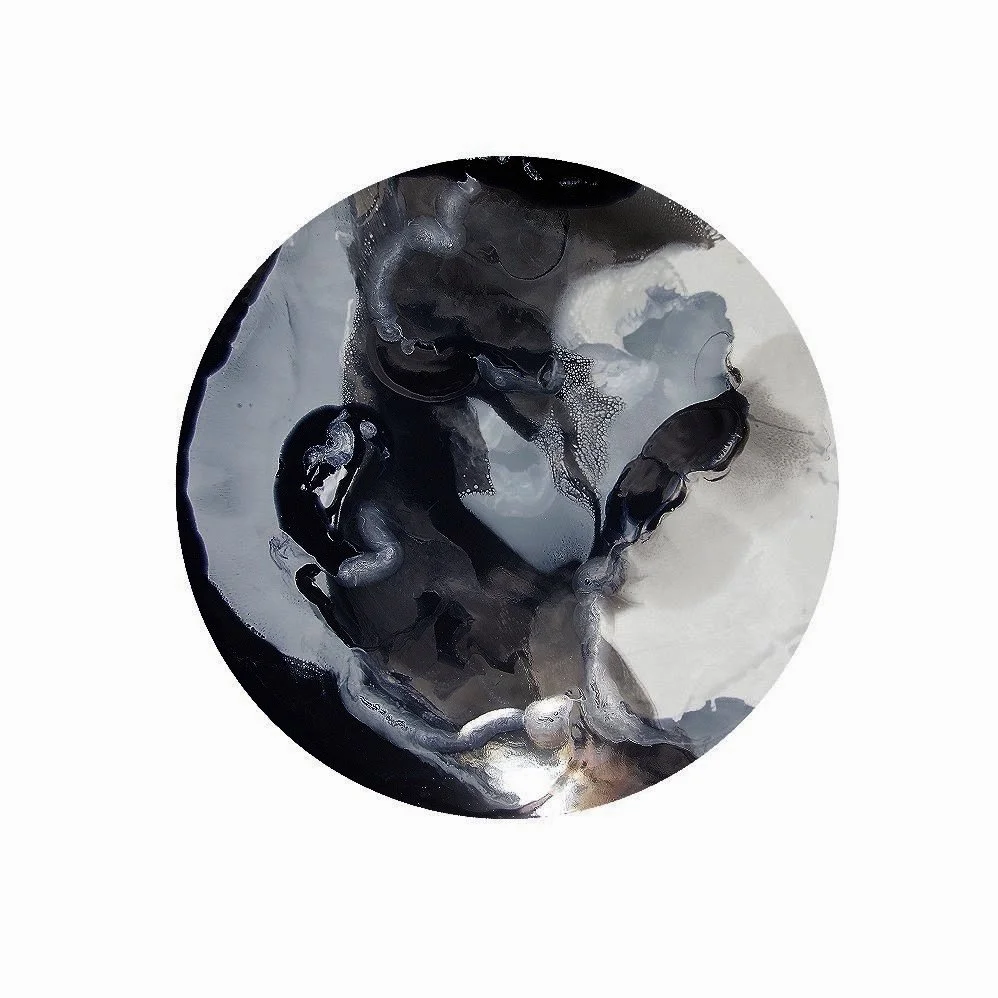 Abstract monochrome artwork with fluid shapes resembling a fetal form within a circular frame.