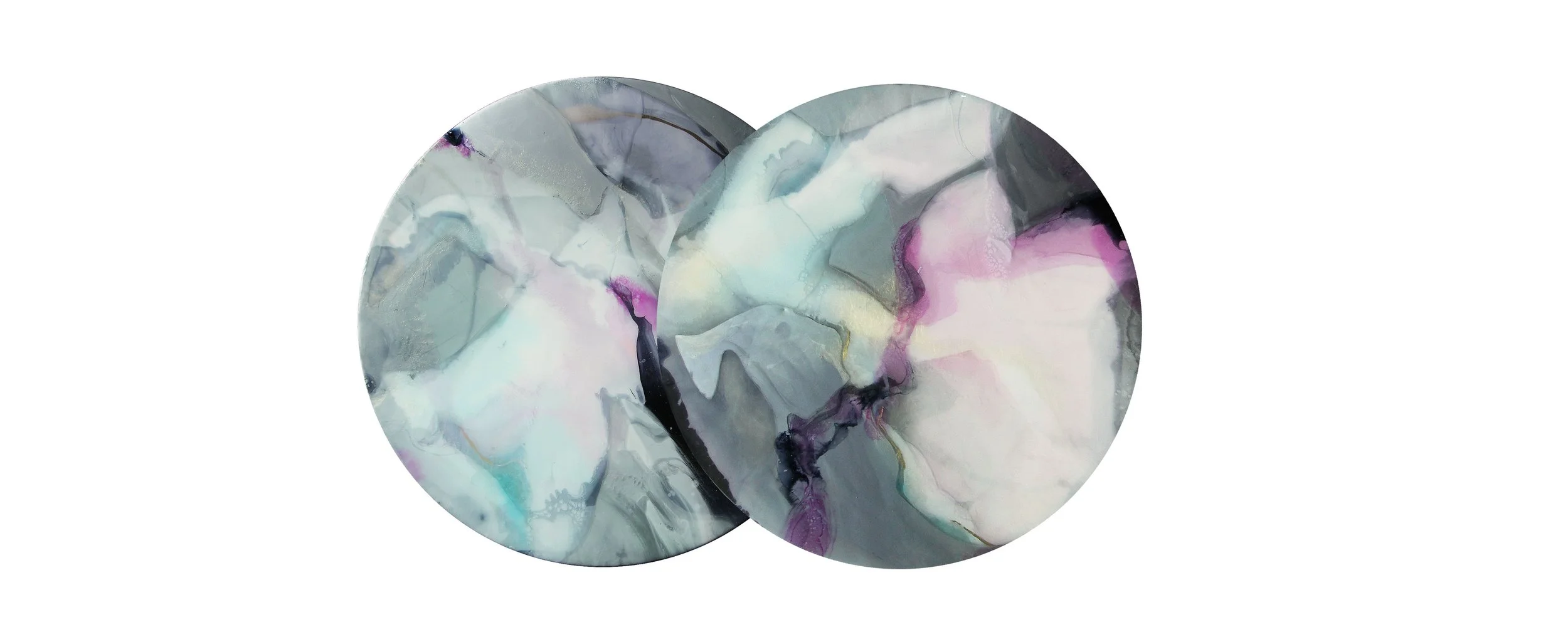 Two abstract circular paintings with swirling pastel and dark colors that was commissioned by Dior, overlapping each other against a white background.