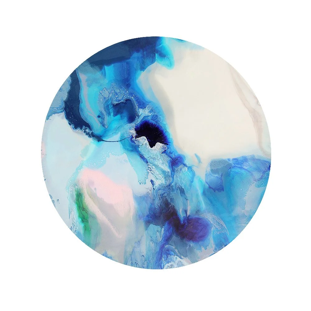 Abstract circular artwork with swirling shades of blue, white, and hints of green and pink.