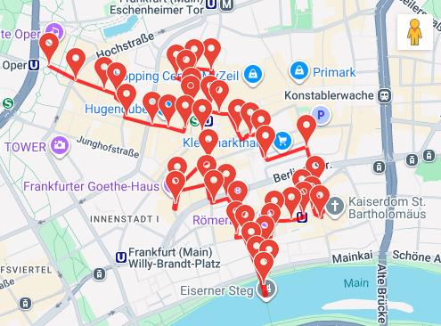 Map of downtown Frankfurt showing numerous red location pins indicating various points of interest along the Main River and surrounding areas.