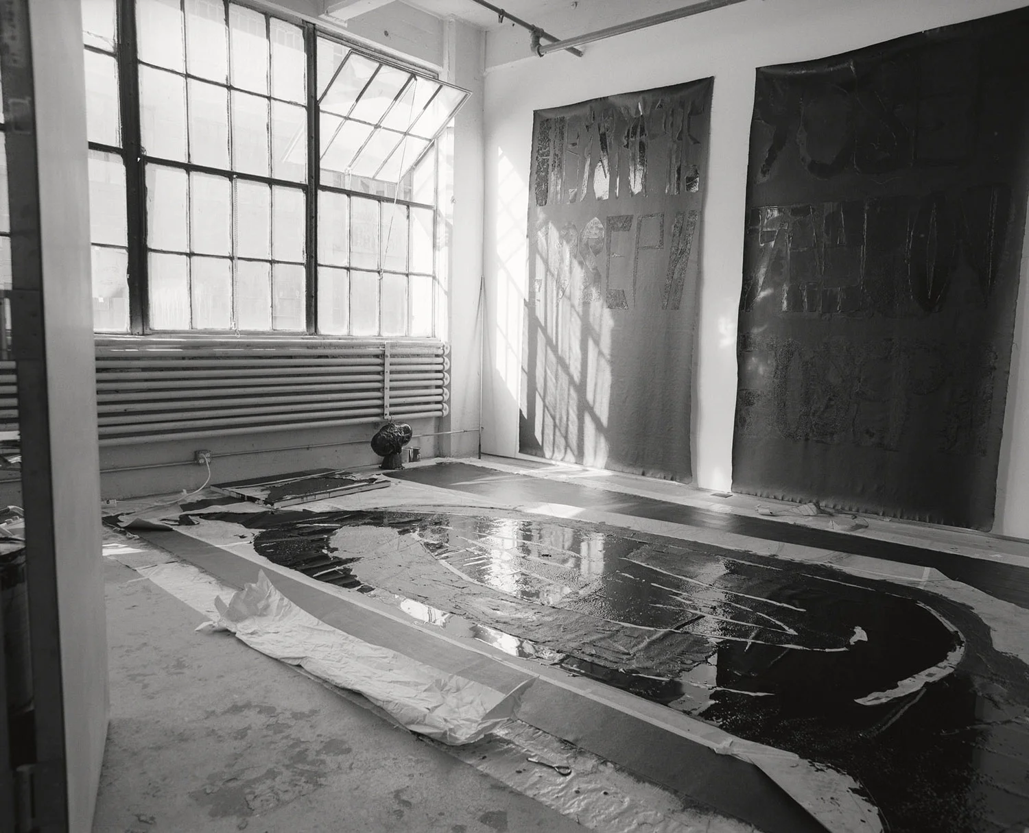 The canvas hanging on the wall on the day it arrived in New Jersey, before being packed for storage. Some sections of thebitumen had not yet dried.