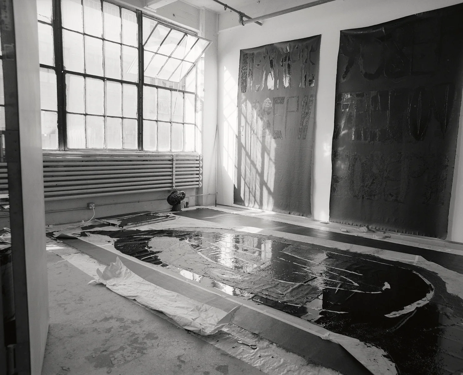 On the wall Left: Christophe Joseph Right: Yosef Yaakov Joseph On the floor Snake 2011-13 ( in progress ). Technique: bituminous mastic, gesso, matte black acrylic paint, Indian canvas. The canvas is placed on the floor, with the Kraft paper placed on top of the canvas, with the bitumen between the open channels in the shape. Brooklyn studio, 2011 Photographer: Amina Hasen