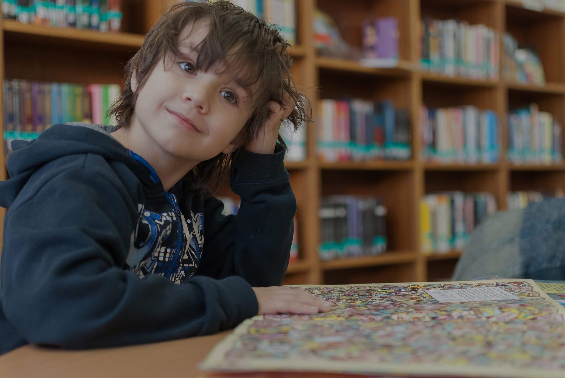 NLI boy in library_dark.png