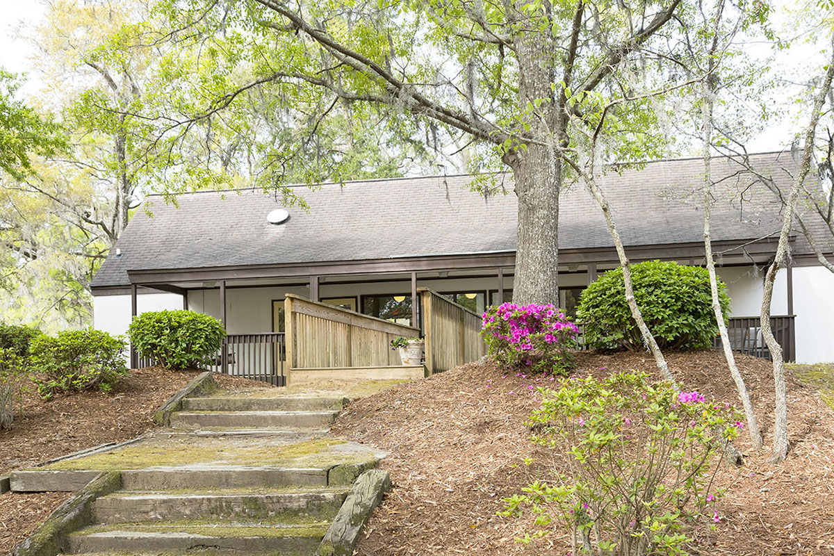 Steps from porch down to the live oak shaded lawn