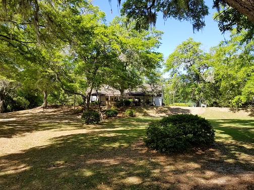 View from the shaded lawn to the Rice Canal Club
