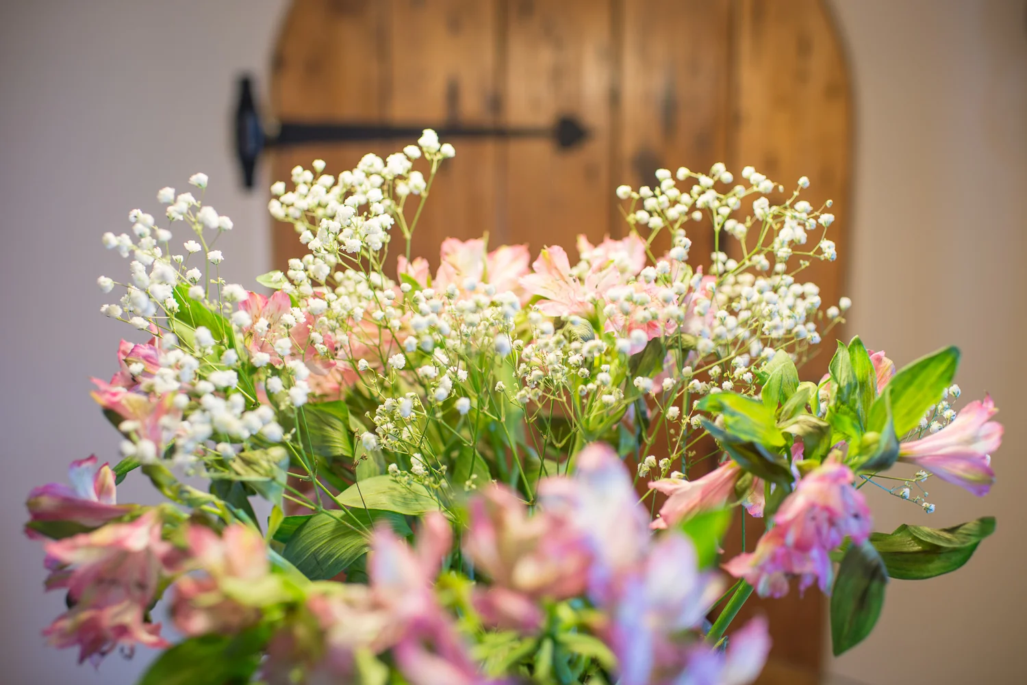 close up of flowers in front of barn door
