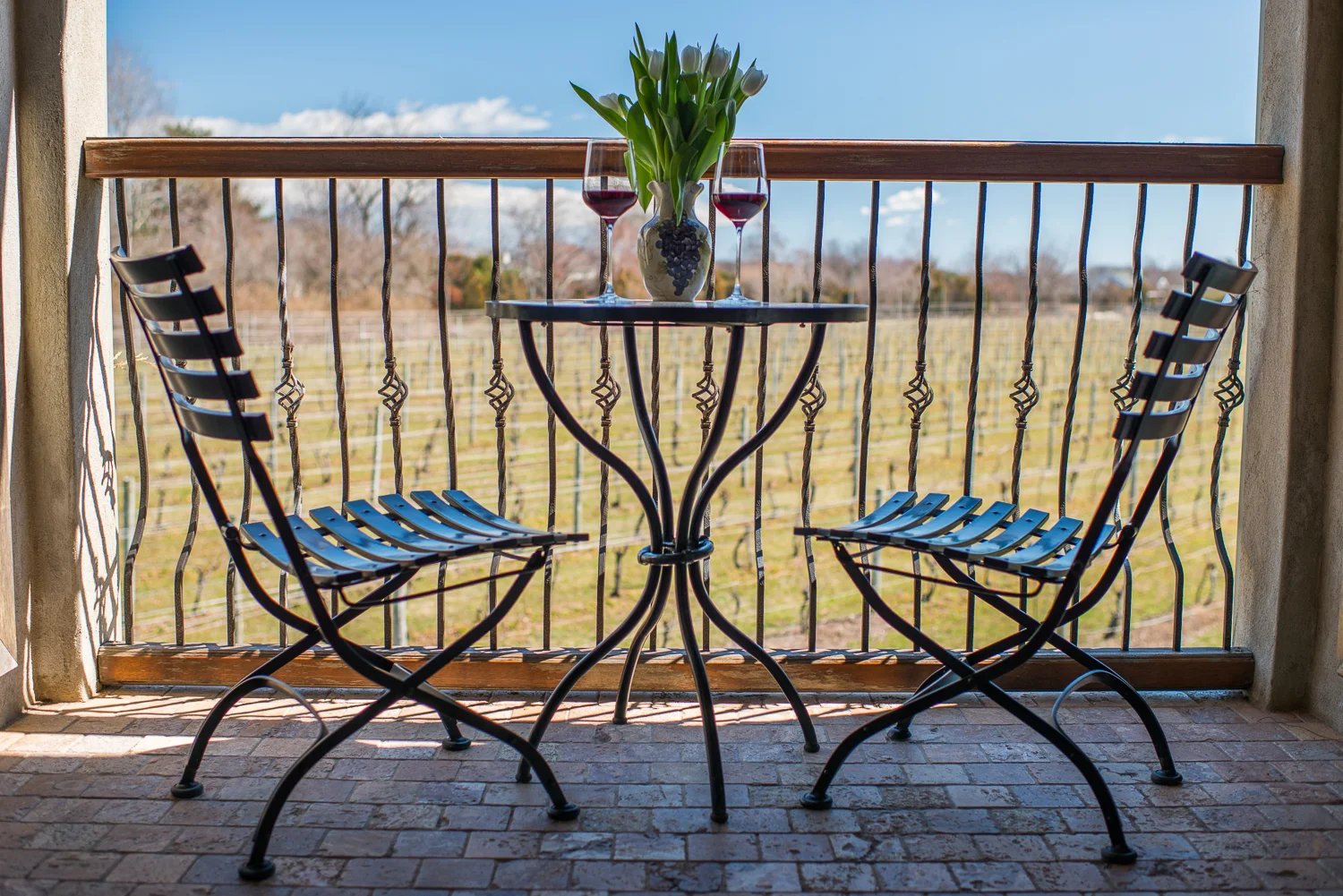 patio with table and chairs with wine glass's on table