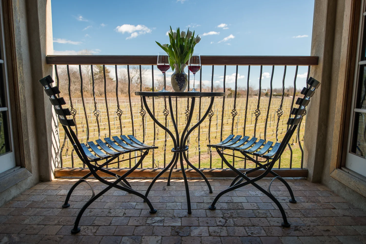 patio with table and chairs with wine glass's on table