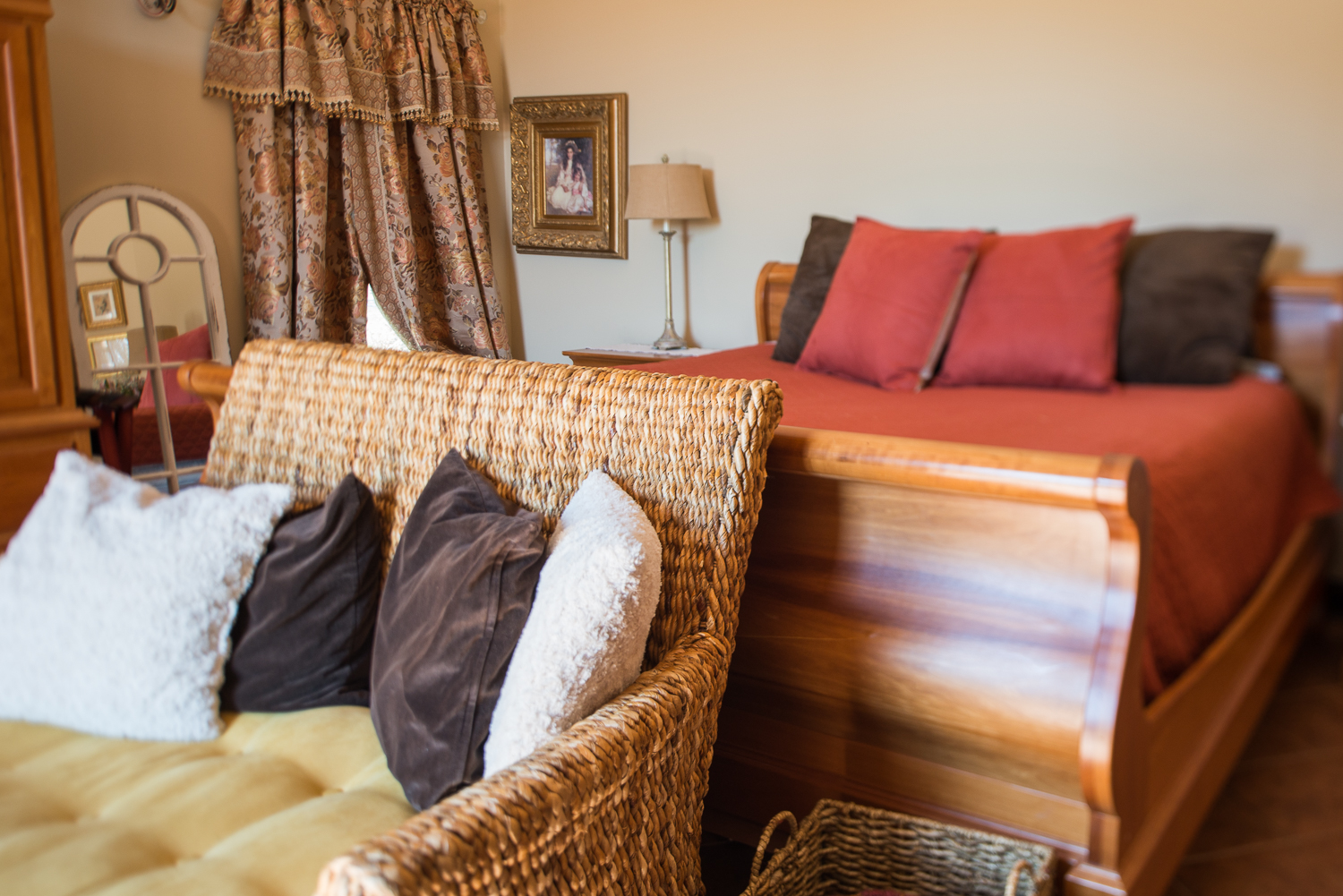 chair and pillows in front of a bed