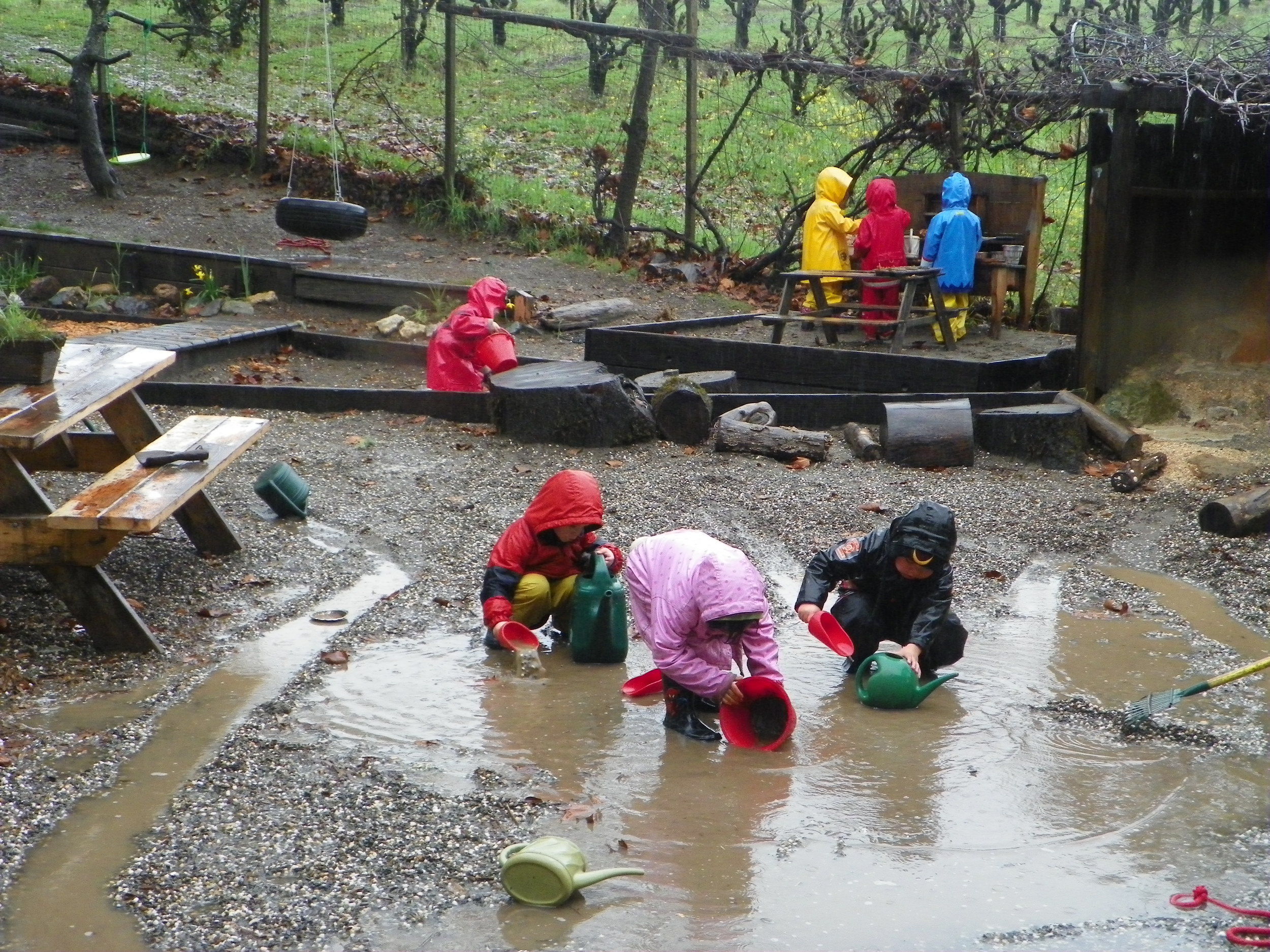 Child play outdoors year round, rain or shine.