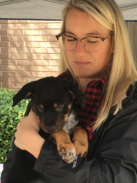 Laura Duncan of The Duncan Gals cuddles a Country Roads' pup. Photo provided.