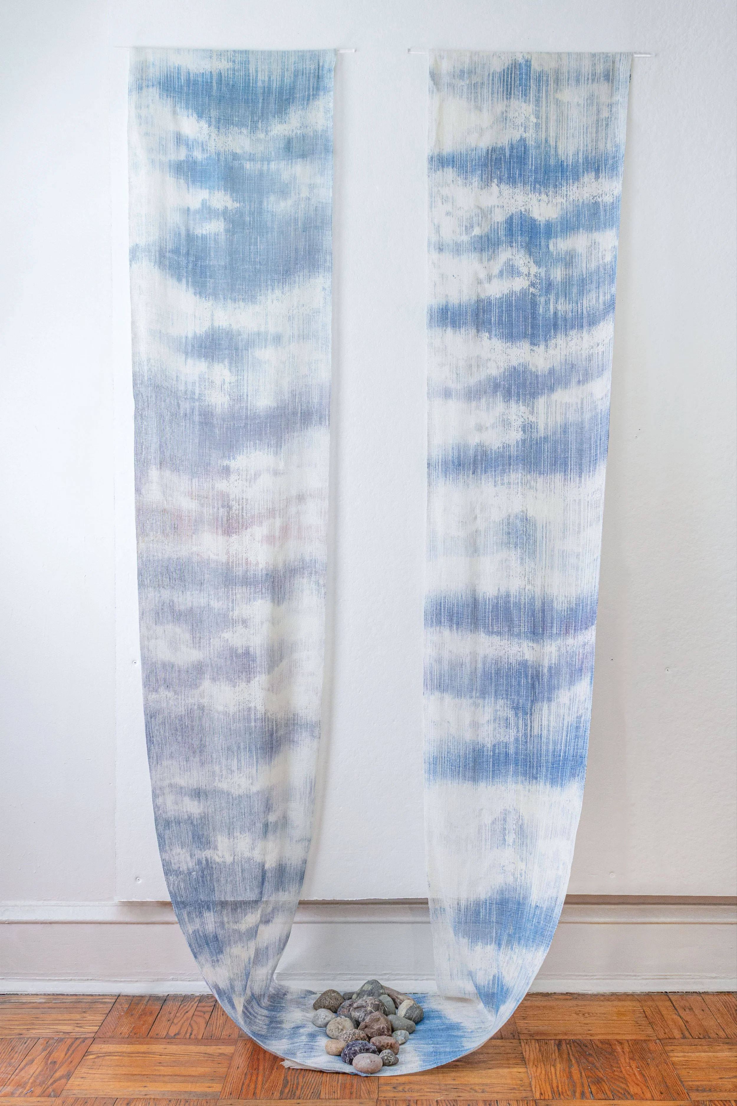 if the wind is still screen print, handwoven cotton, stones 8’ x 4’ x 2’ 2025