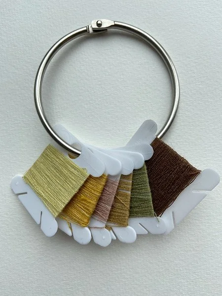 Silk embroidery thread dyed in goldenrod, onion skins, avocado stones, and walnut.
