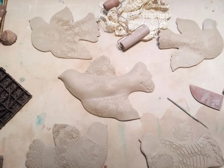 making and texturing porcelain wall birds.