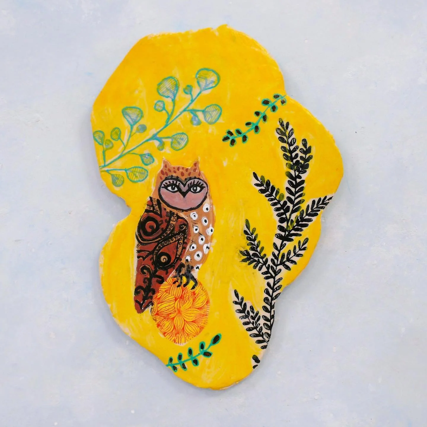 Can&rsquo;t get enough of this yellow! Owl on red egg with branches and flowers, ceramic wall plaque.