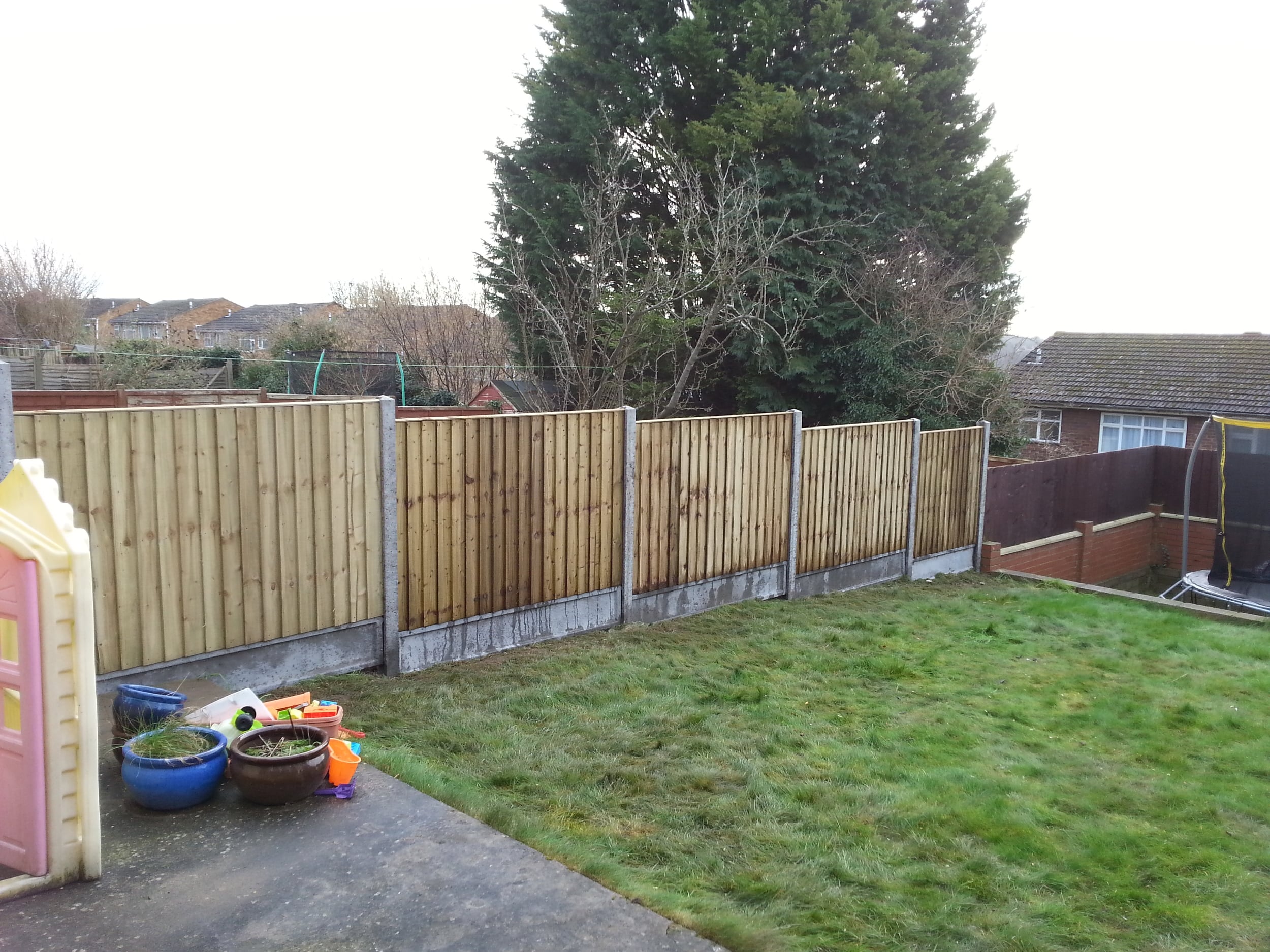 Closeboard panels on concrete posts and gravel boards, Downley
