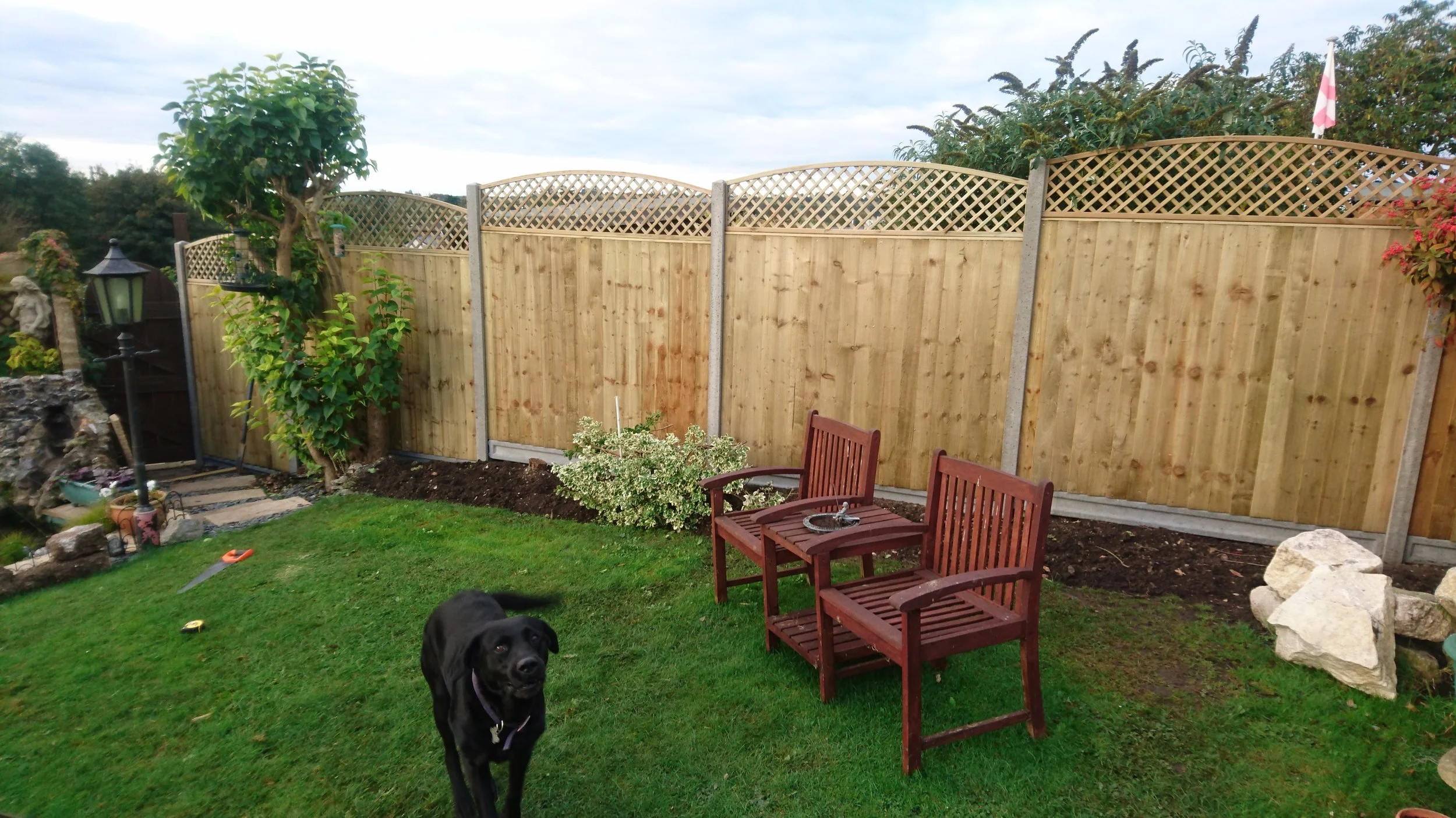 Closeboard panels with trellis on concrete posts and gravel boards, Bourne End