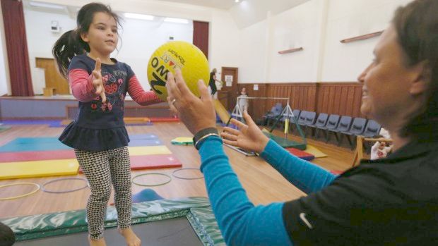 Jenny Dravitzki, left of Sport Tasman throws a ball to Quayde McIntyre, 4, at the Toddler Better Health Programme at the Richmond Town Hall.