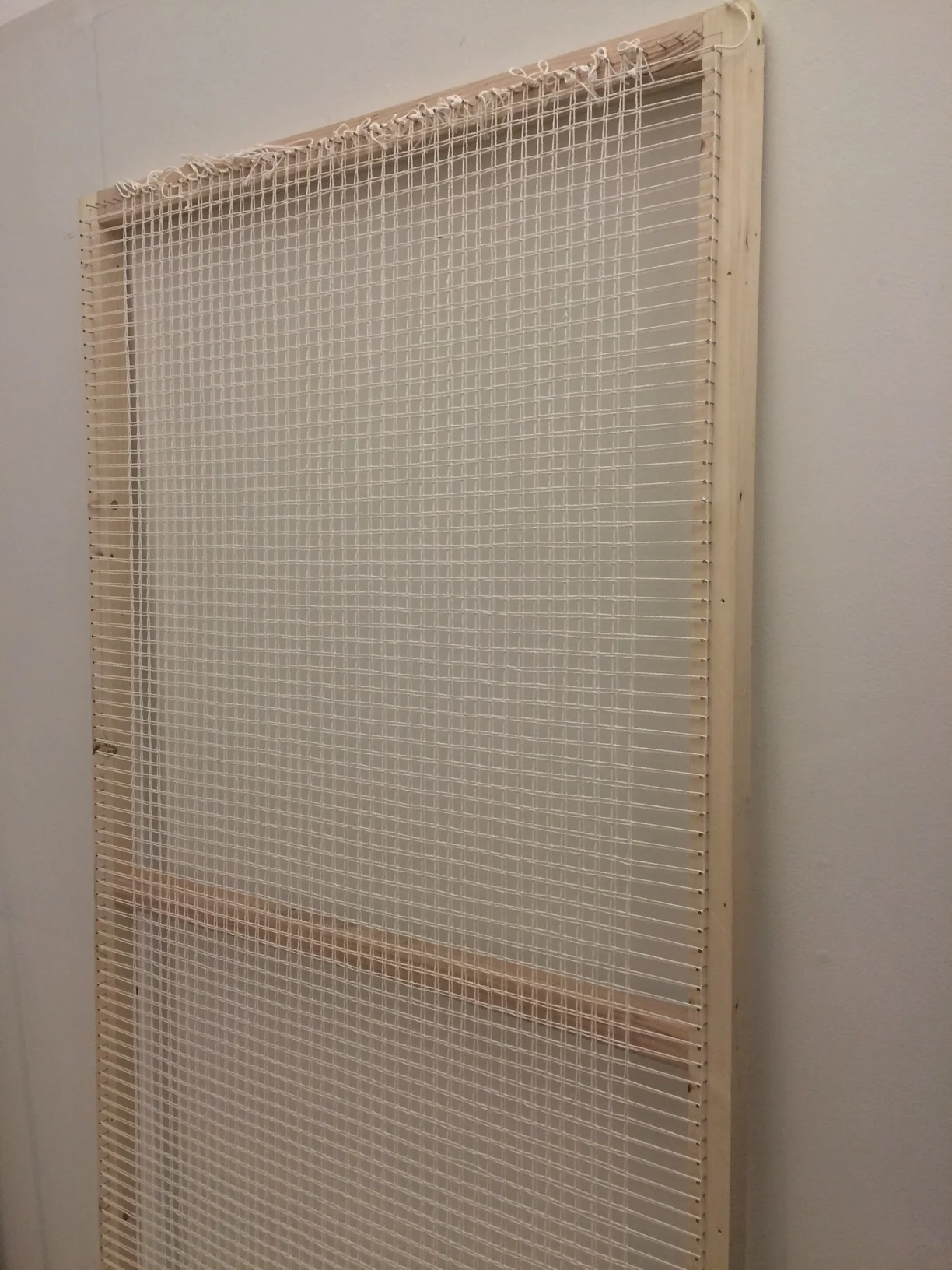 Frame loom prepped with cotton cord.