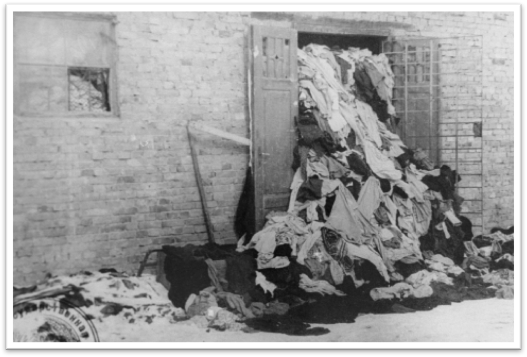 View of one of the warehouses in Auschwitz, overflowing with clothes confiscated from prisoners, 1945