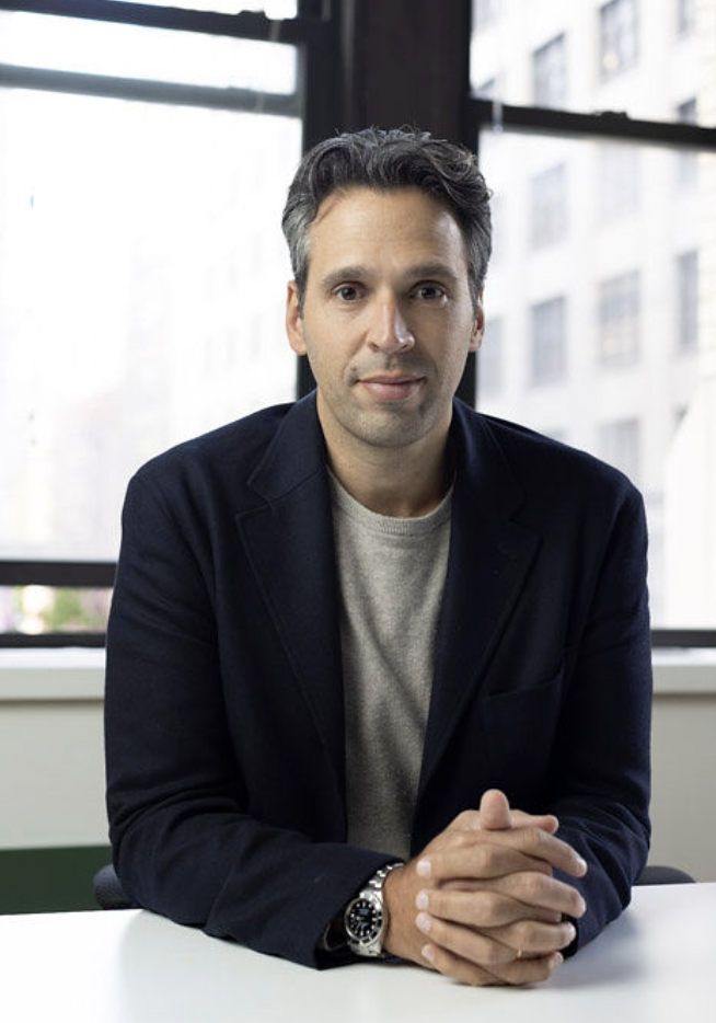 Photo of smiling man in jacket.