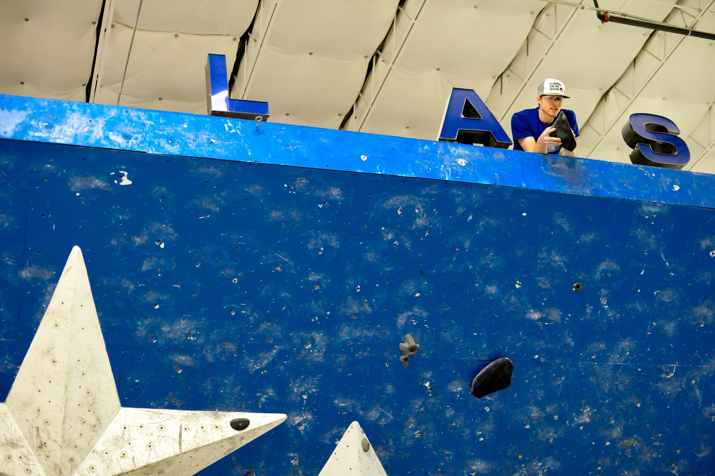 Let's play spot the routesetter! Setter Jon Correll scoping out the finish hold for a competition finals problem.