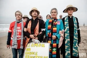 Bonnie Tarwater (second to the right), a minister of Church for our Common Home, walks with other religious faith leaders to the border fence at Border Field State Park in San Diego, California on December 10, 2018. Photo by Ariana Drehsler/UPI