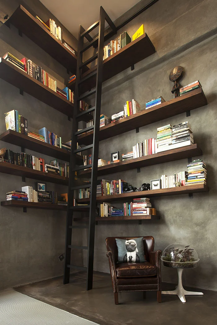 Interlocking walnut shelving system with 15-foot steel ladder.