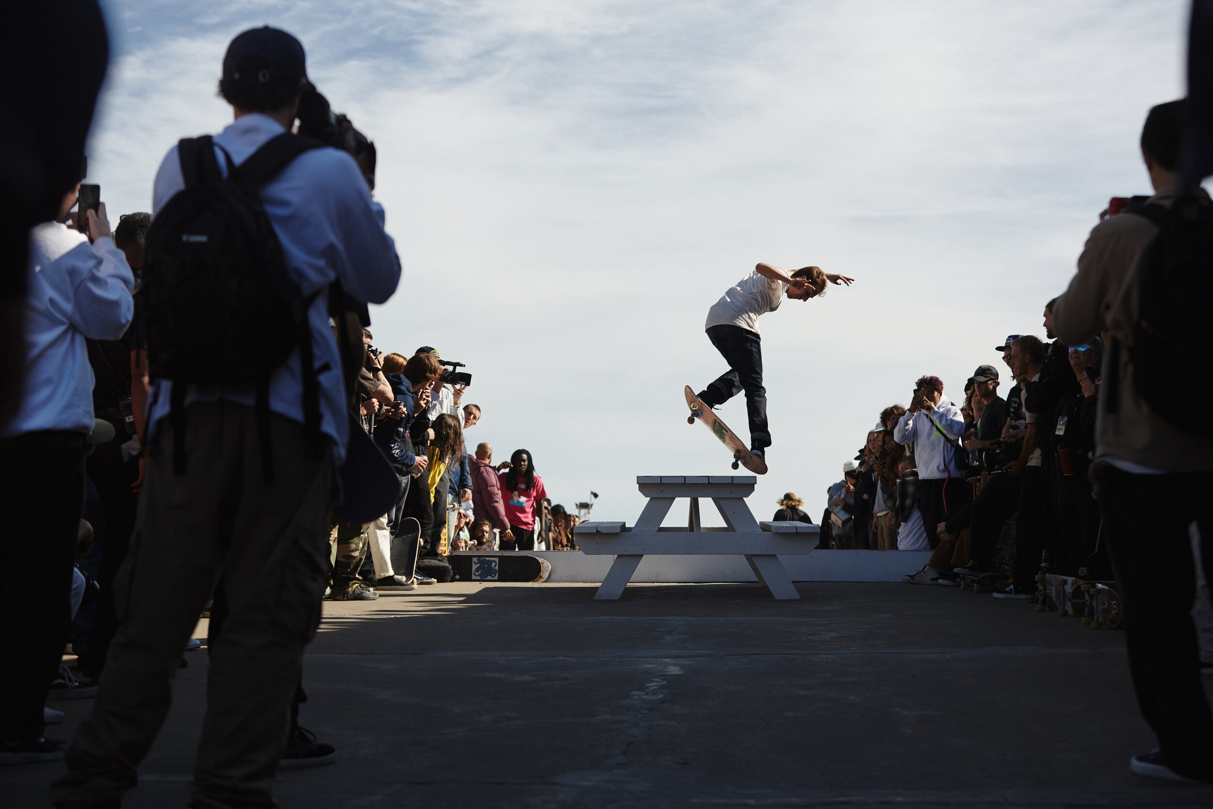 Mark Suciu (kickflip back noseblunts a table) at Dime's "Live at Olympic Stadium" for GQ