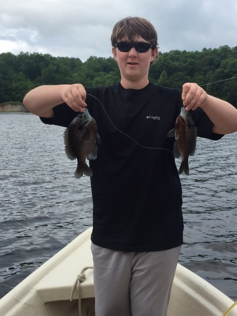 Aiden proudly displaying his first fly rod caught double header bluegills coming fresh from the front of the cow pasture