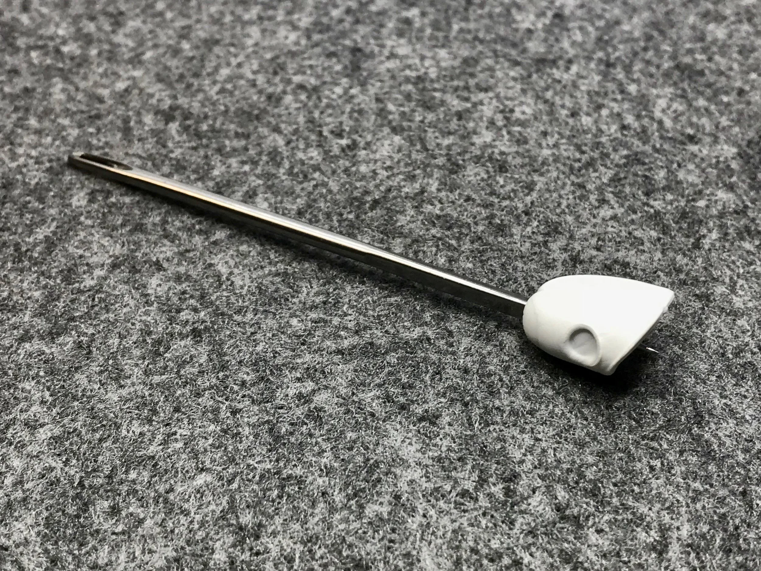 Making a hole with a large needle is required in order to slide the popper body onto the kinked shank hook