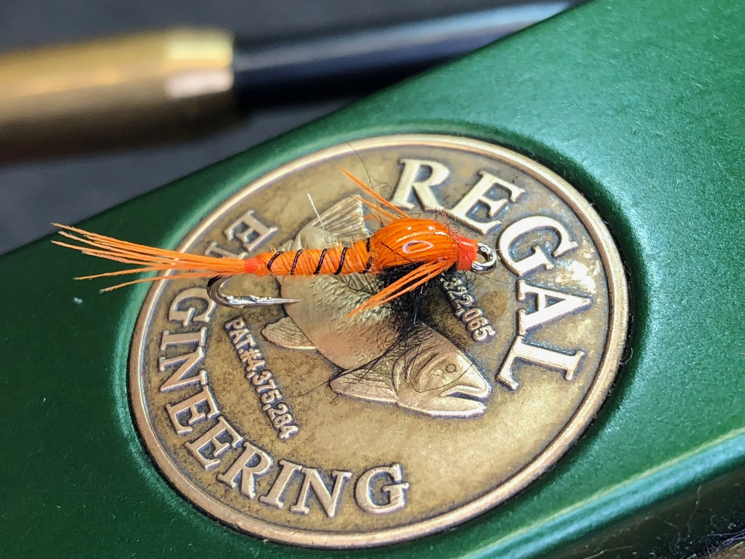 The Panfish Pheasant Tail Nymph swaps out natural pheasant tail fibers for some dyed flourescent orange.
